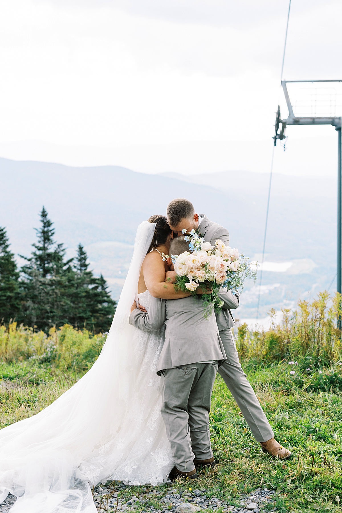 Family shares a big hug together at The Lodge at Spruce Peak