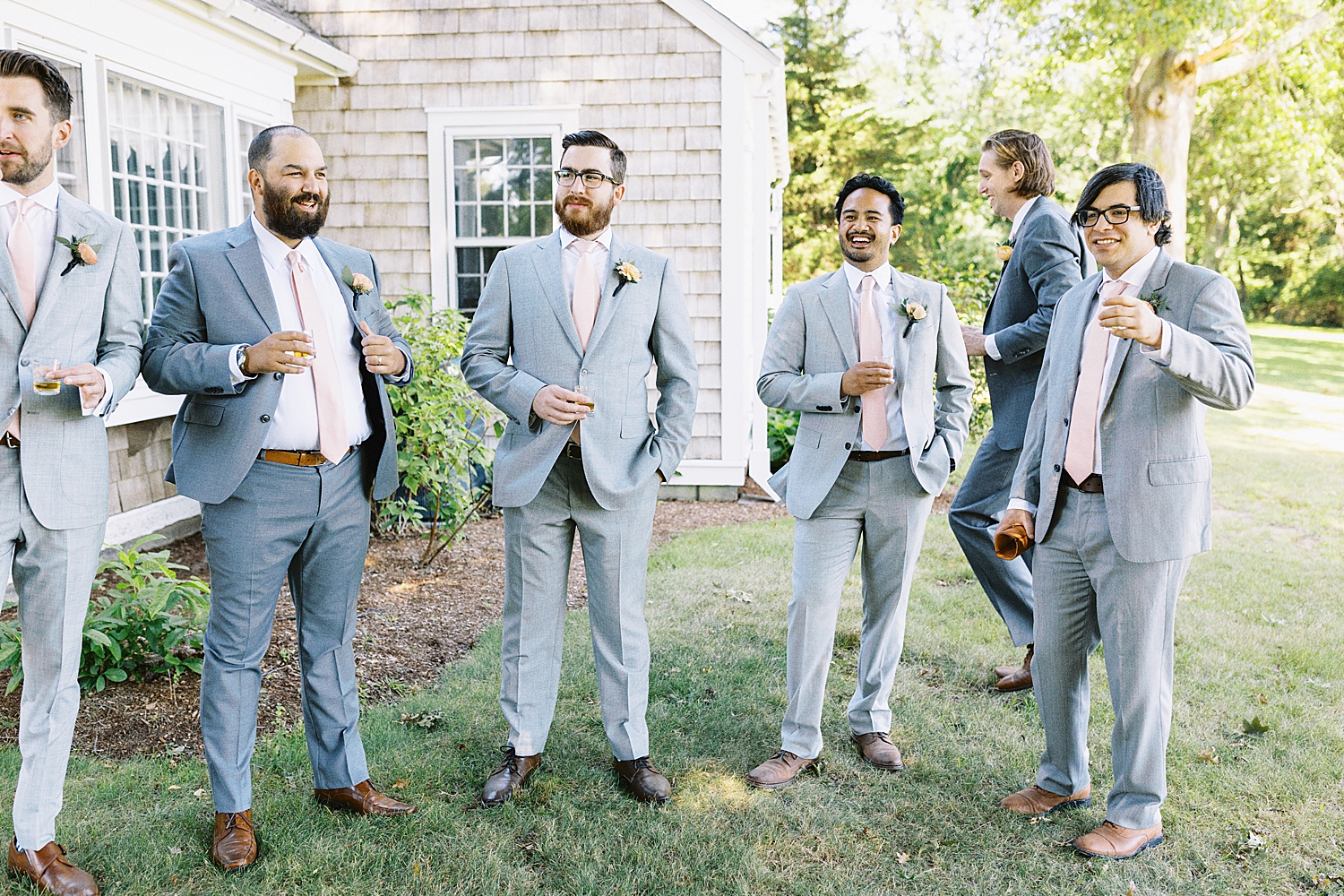 groomsmen share drink outside at Mount Hope Farm