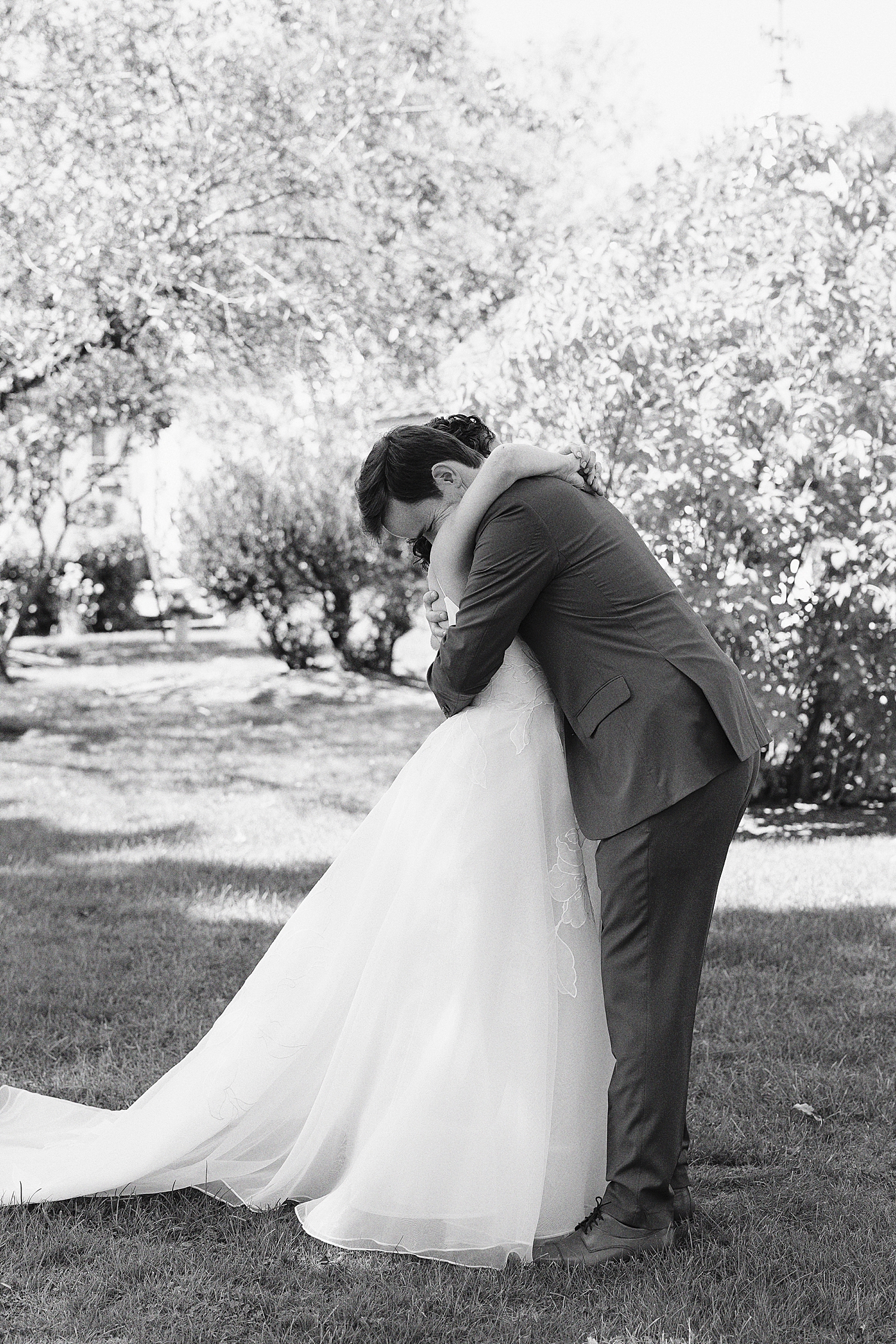 groom hugs fiance during first look at Mount Hope Farm
