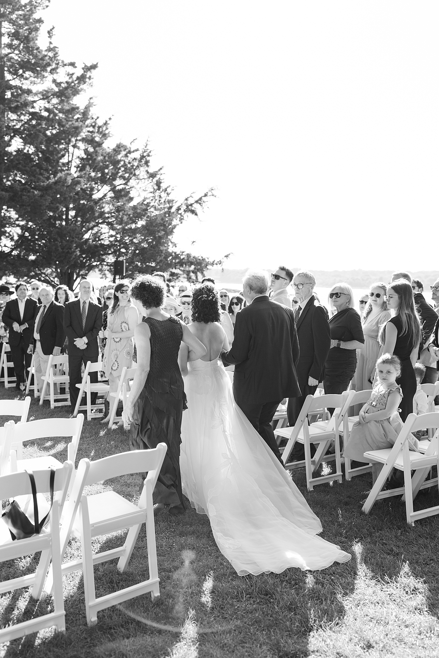 bride walks down the aisle with her parents at Mount Hope Farm