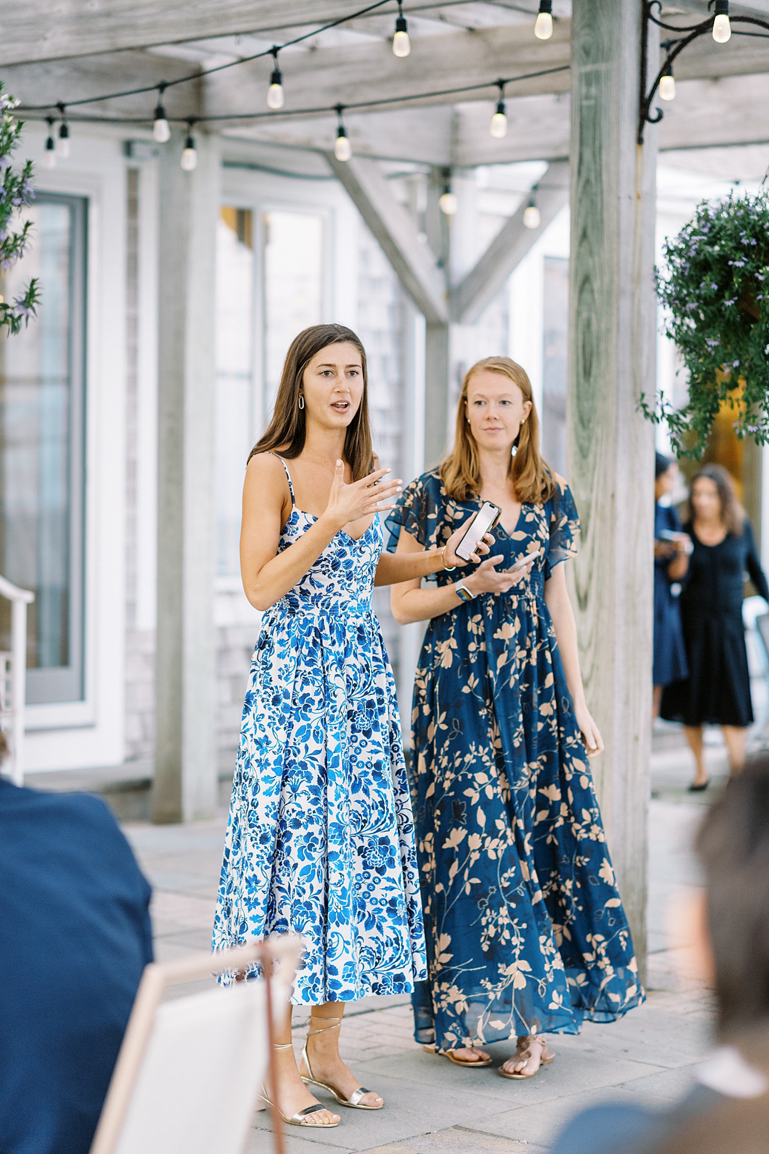 two women give toasts at rehearsal dinner by Lynne Reznick photography