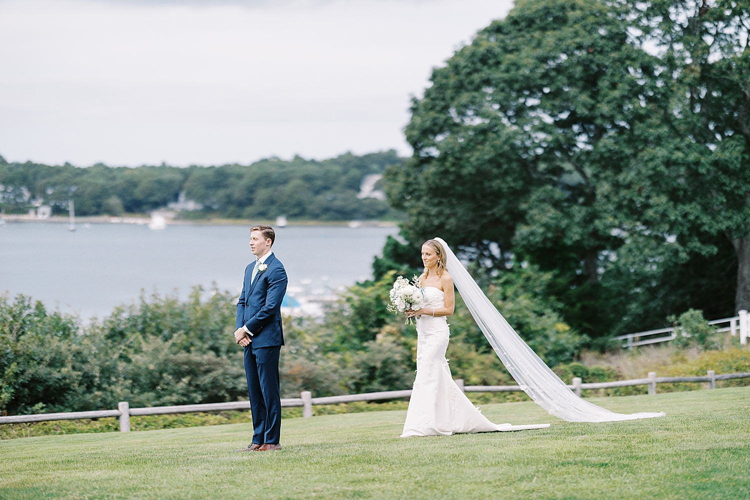 bride approaches groom for first look on lawn by Lynne Reznick Photography