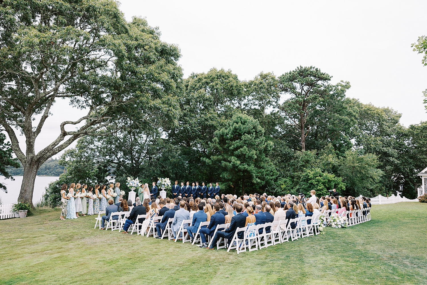 guests watch beautiful lawn ceremony by Cape Cod wedding photographer