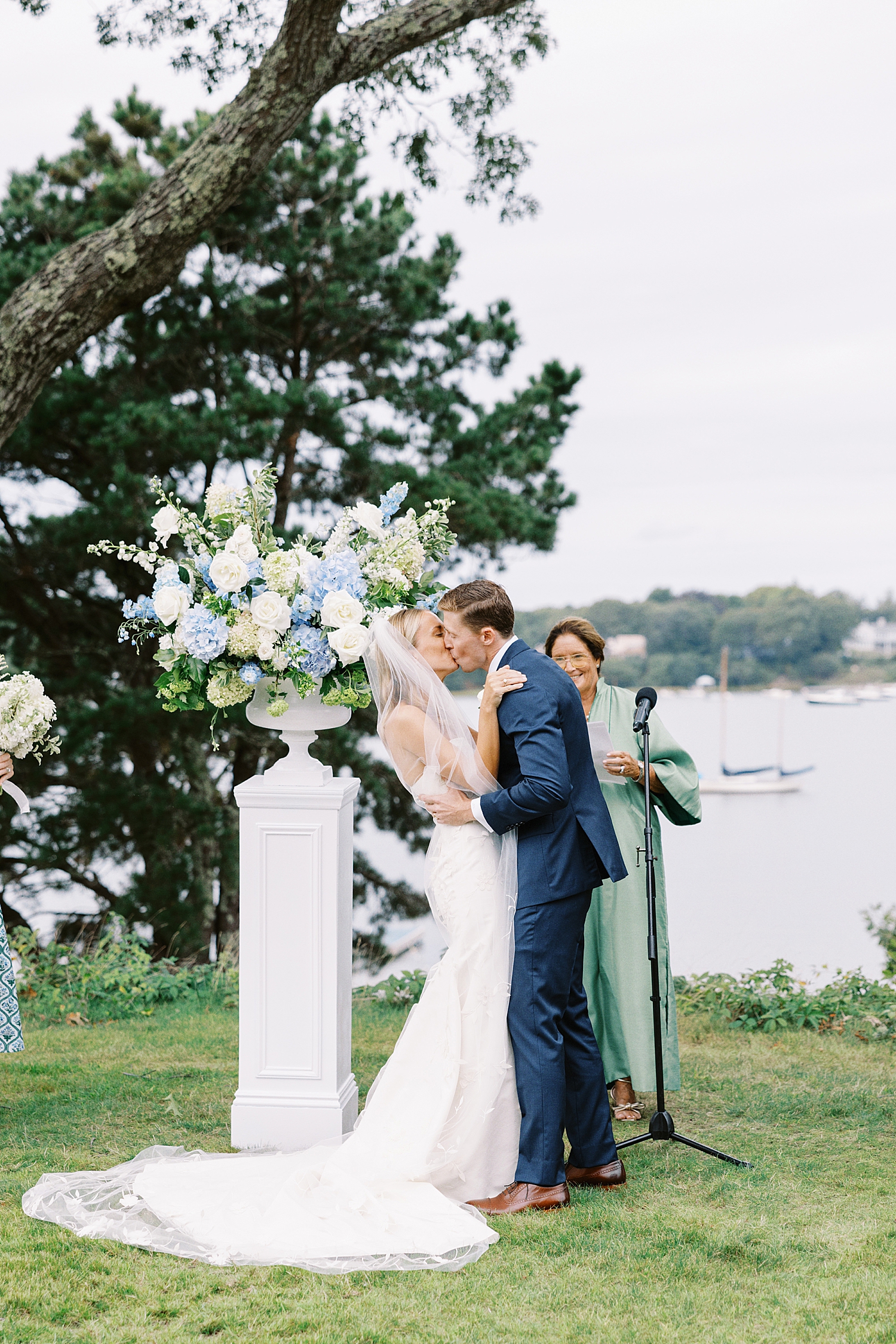 newlyweds share first kiss at alter at Oyster Harbors Club