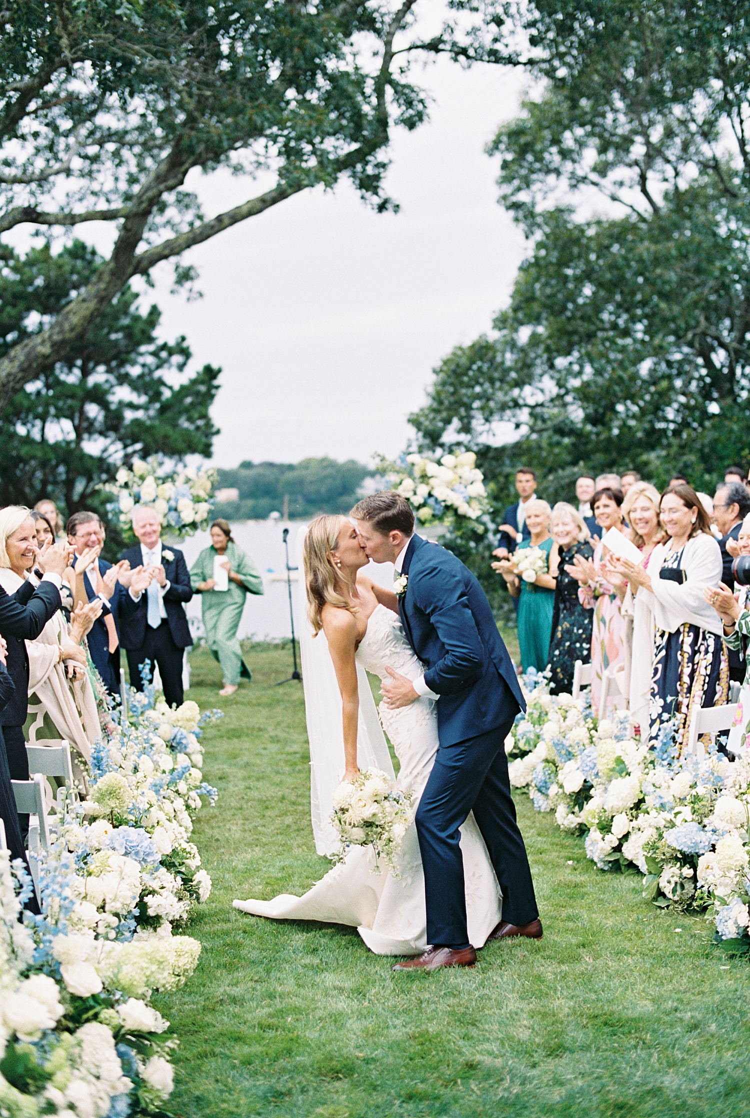 groom dips wife for kiss at aisle by Lynne Reznick Photography