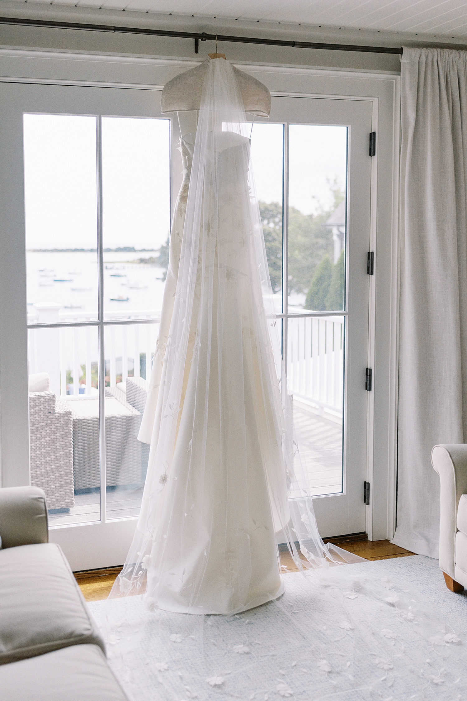 wedding gown hung from windows at Oyster Harbors Club