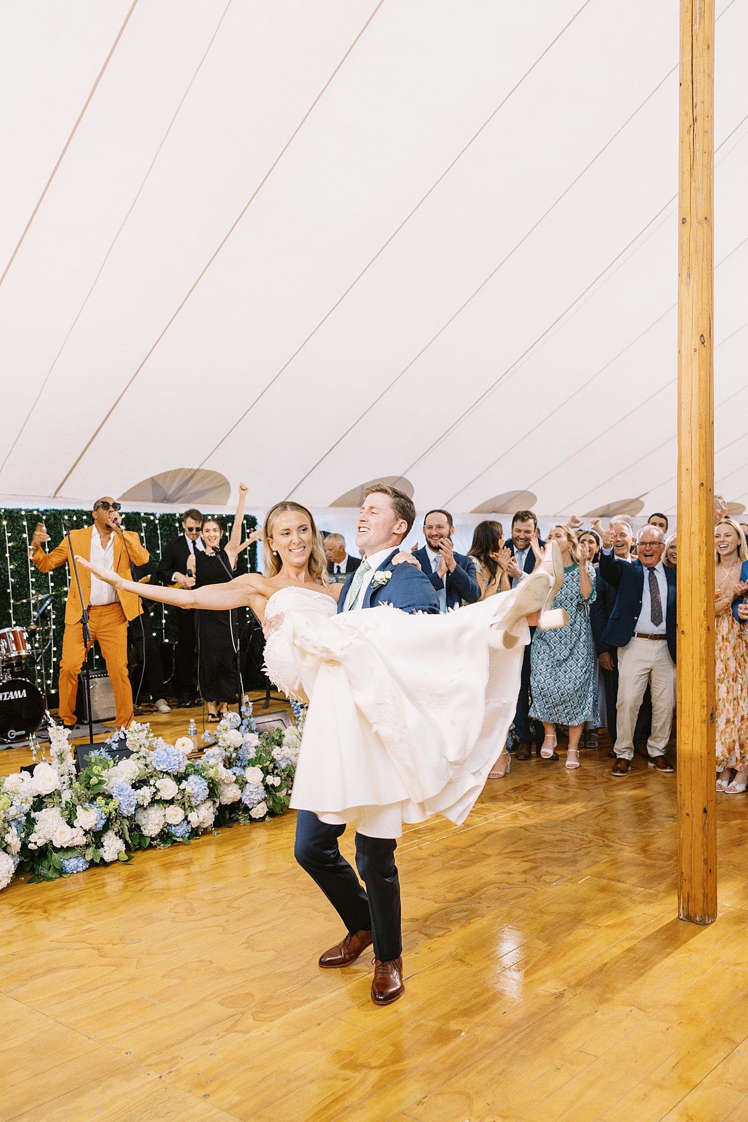 husband spins his wife on dance floor by Cape Cod wedding photographer