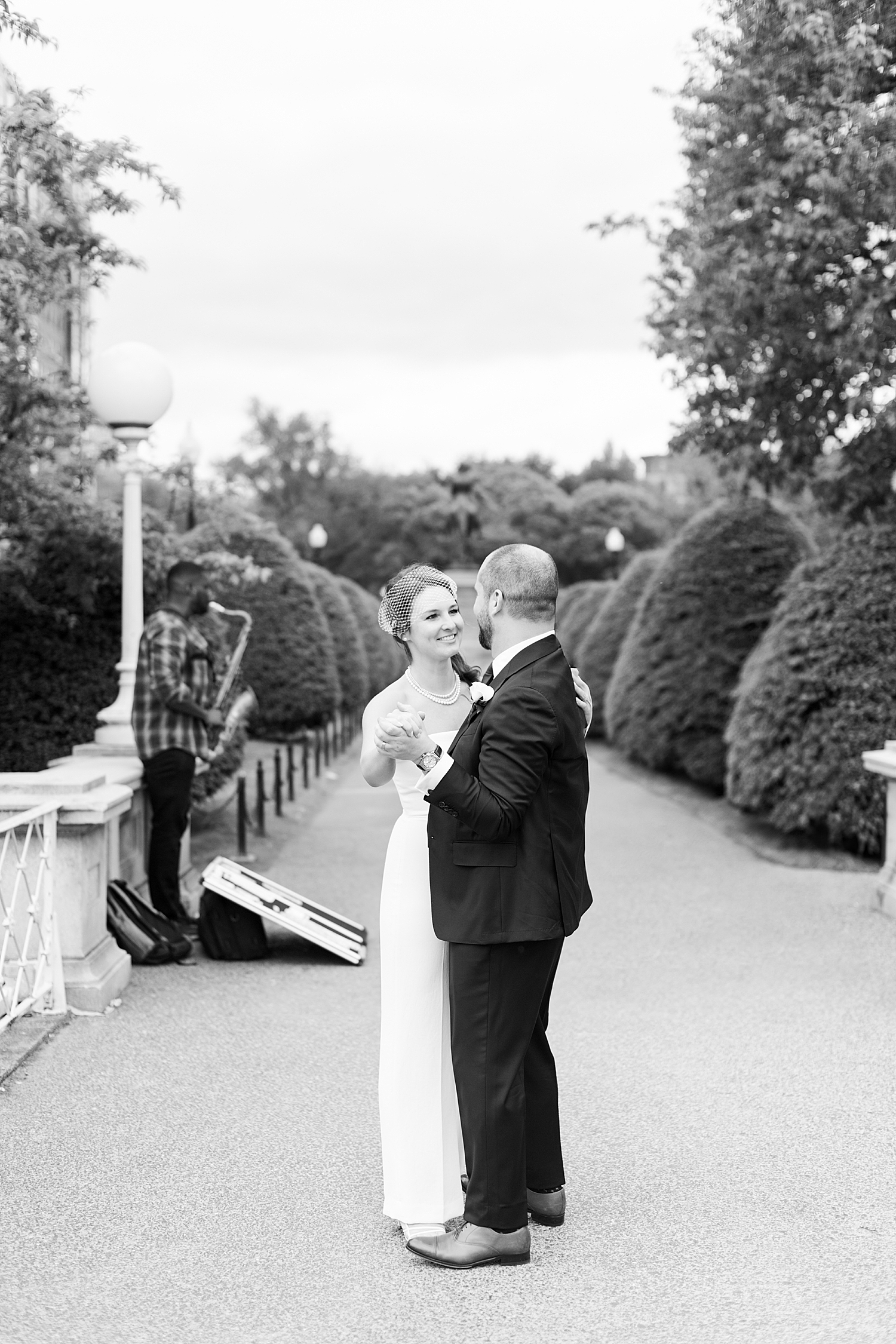 couple dance to street musician on sidewalk by New England Wedding Photographer