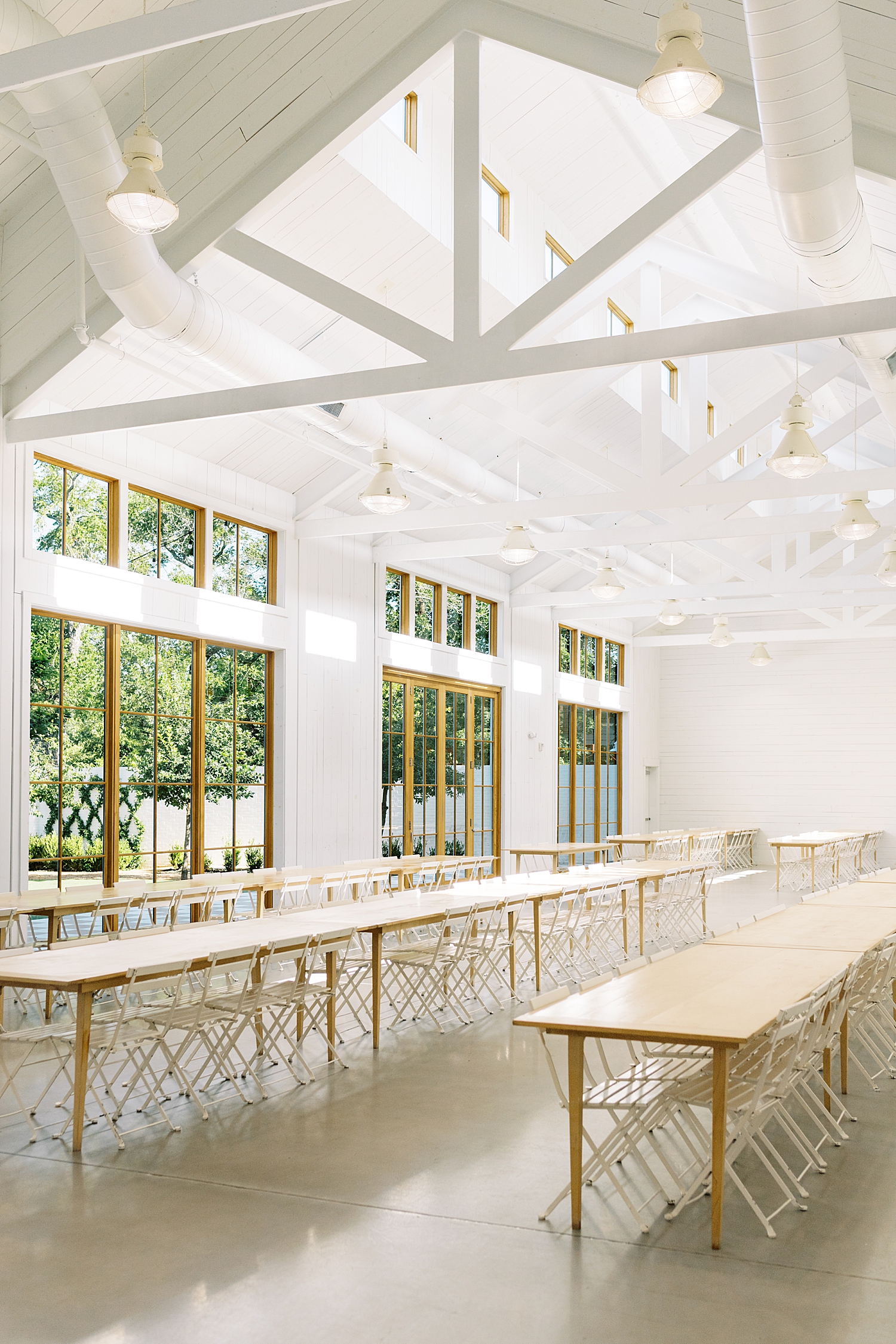large eating hall with vaulted ceilings and big windows by Lynne Reznick Photography