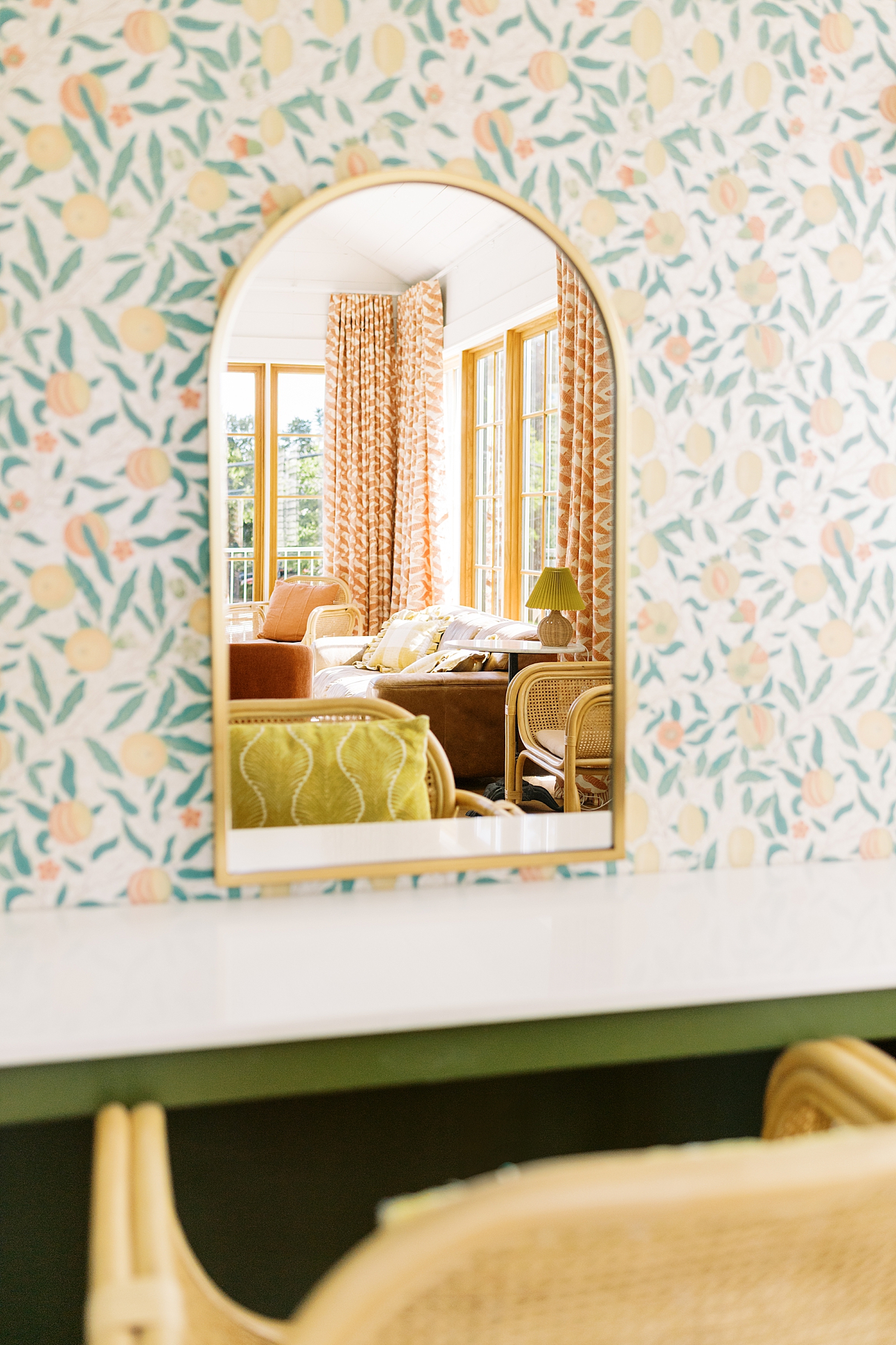 arched mirror on peach wallpaper hangs in getting ready room by Austin wedding photographer
