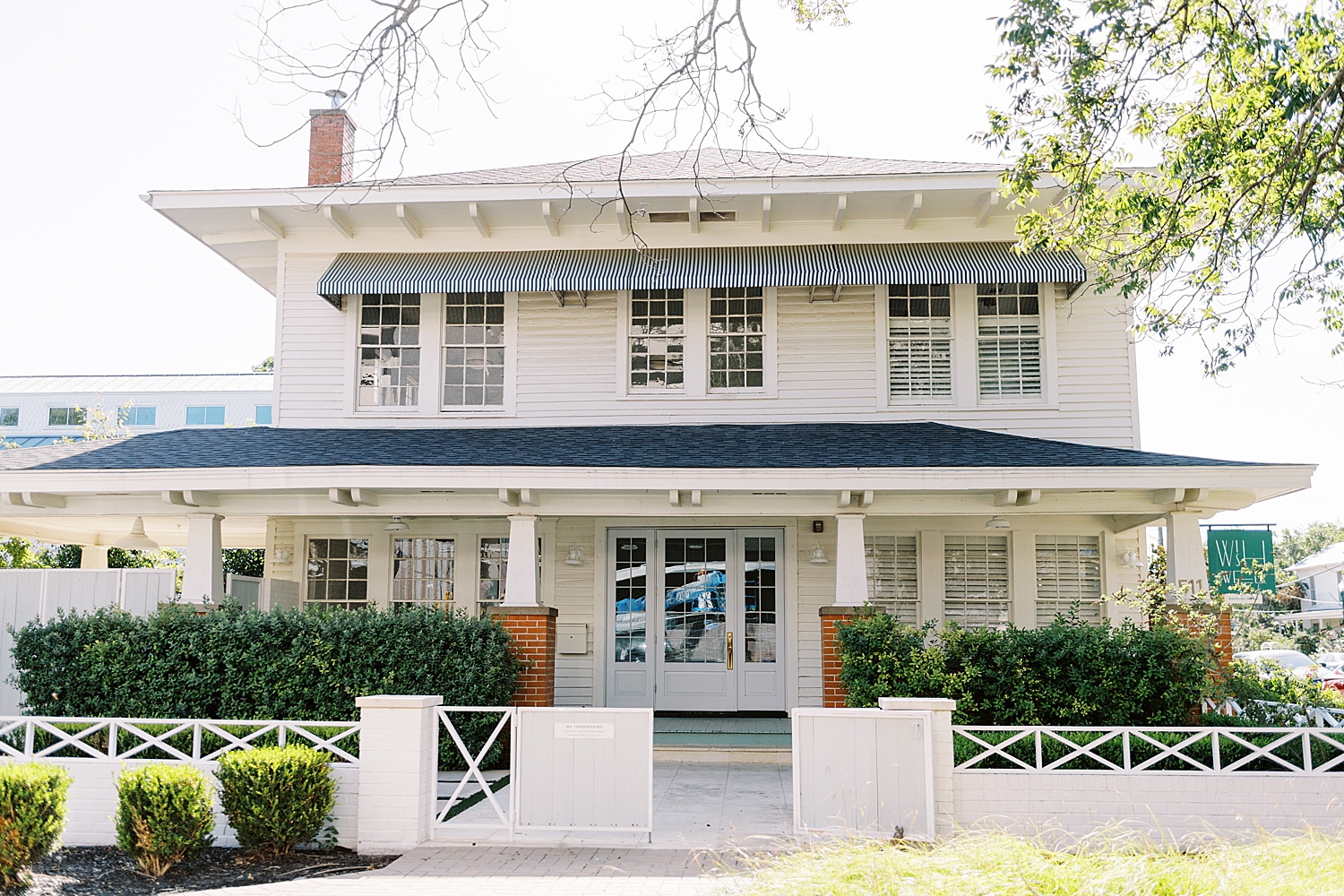 large white house facing the street by Lynne Reznick Photography