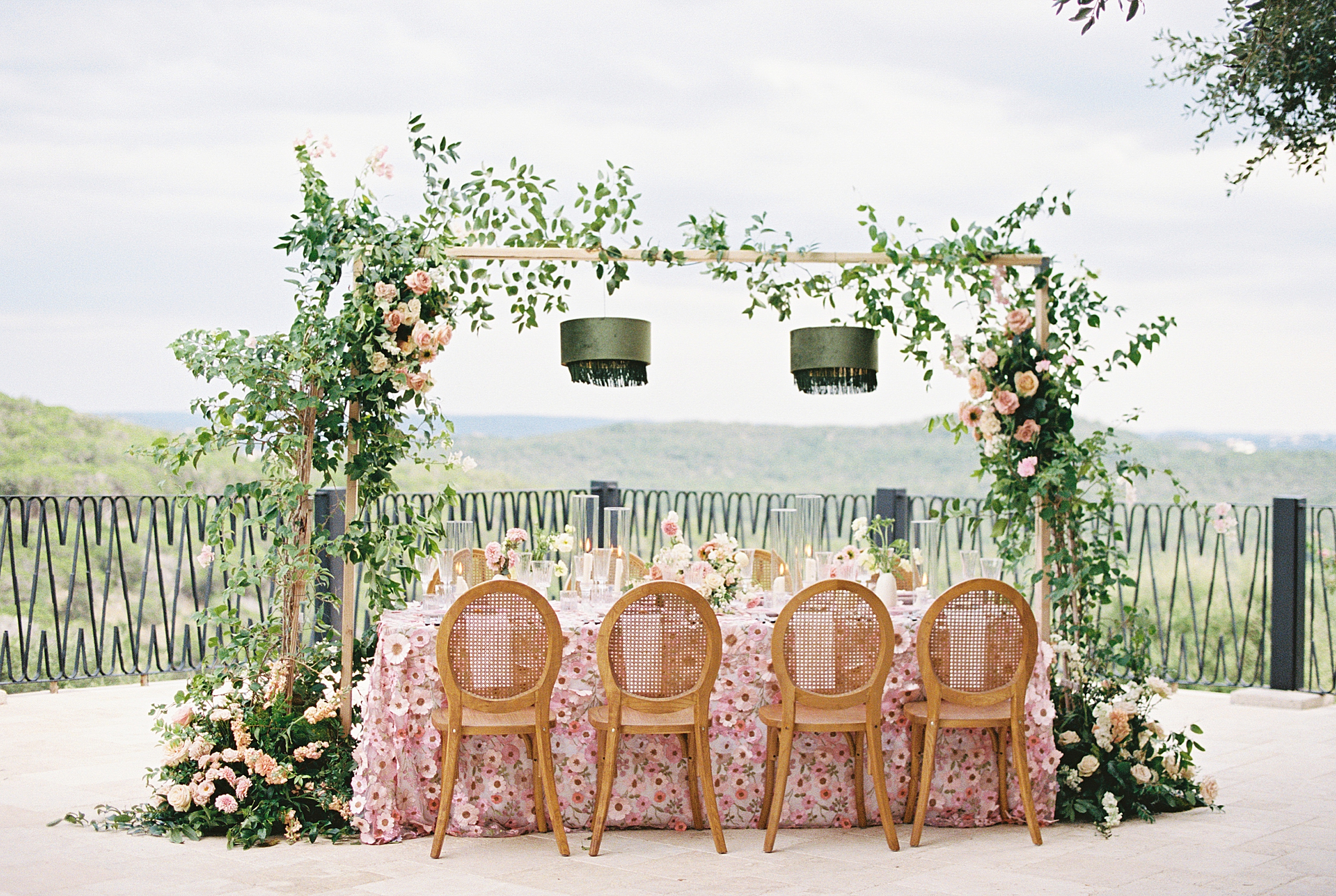 pink floral tablescape with green hanging lanterns set for wedding at Villa Antonia