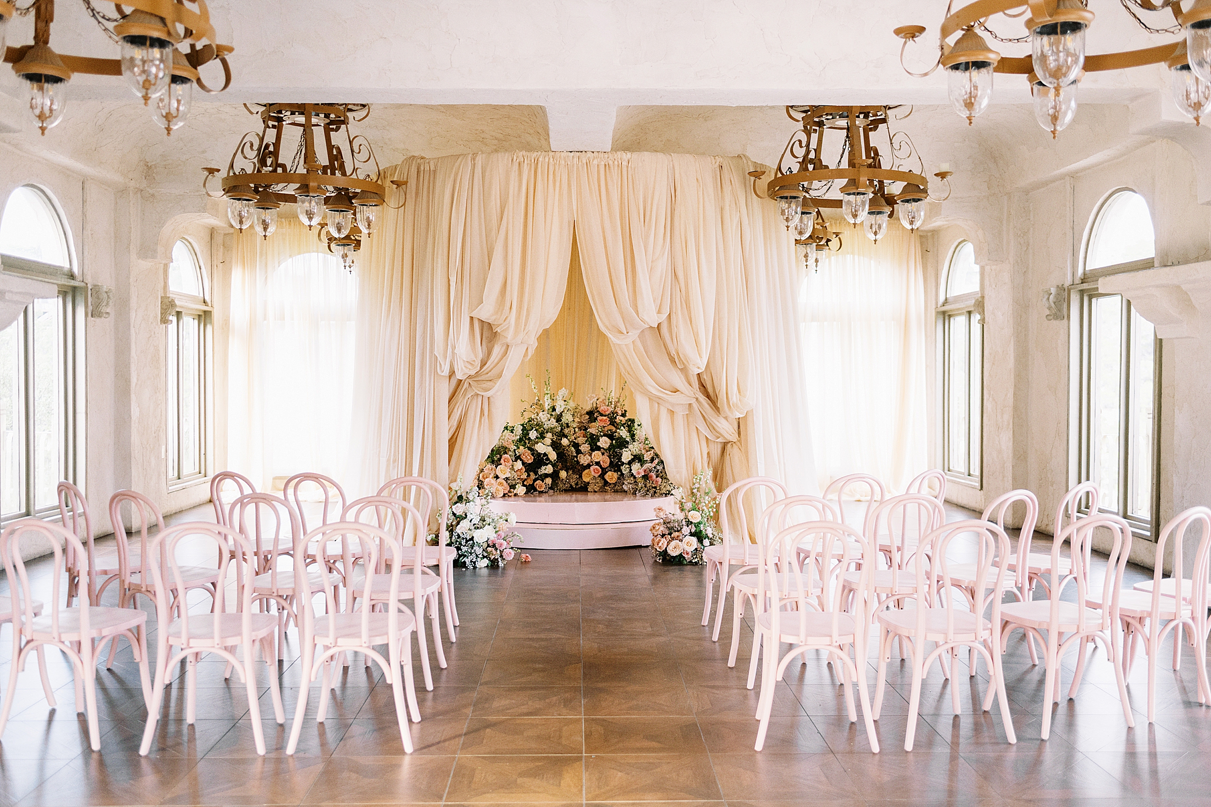 peach drapery and lush florals at Villa Antonia wedding