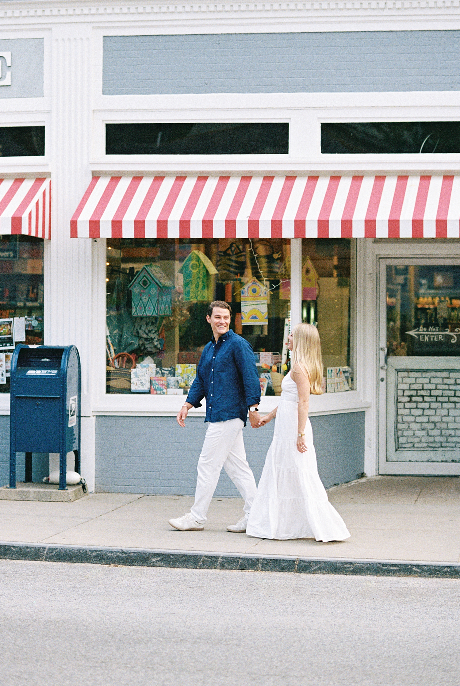 man and woman walk down town street by New England wedding photographer
