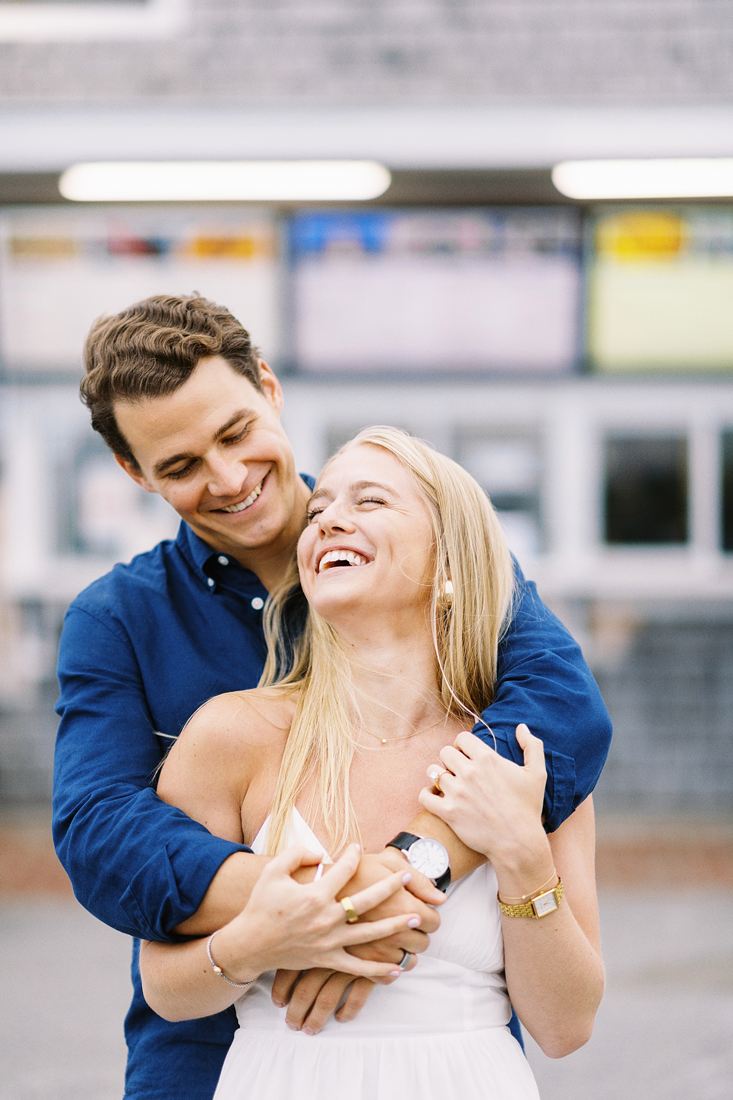 blonde leans back into her man laughing by New England wedding photographer