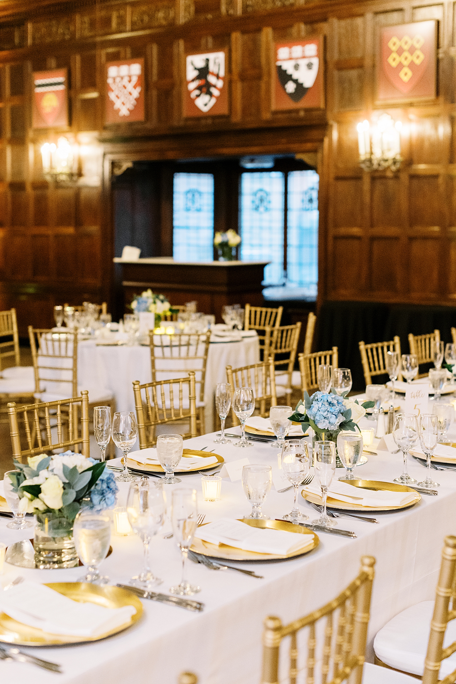 gold chairs surround white and blue tables by Lynne Reznick Photography