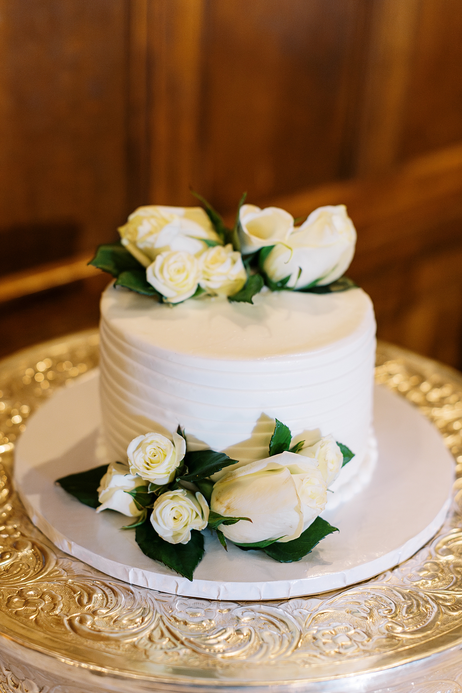 small white wedding cake with white roses at Havard Club of Boston
