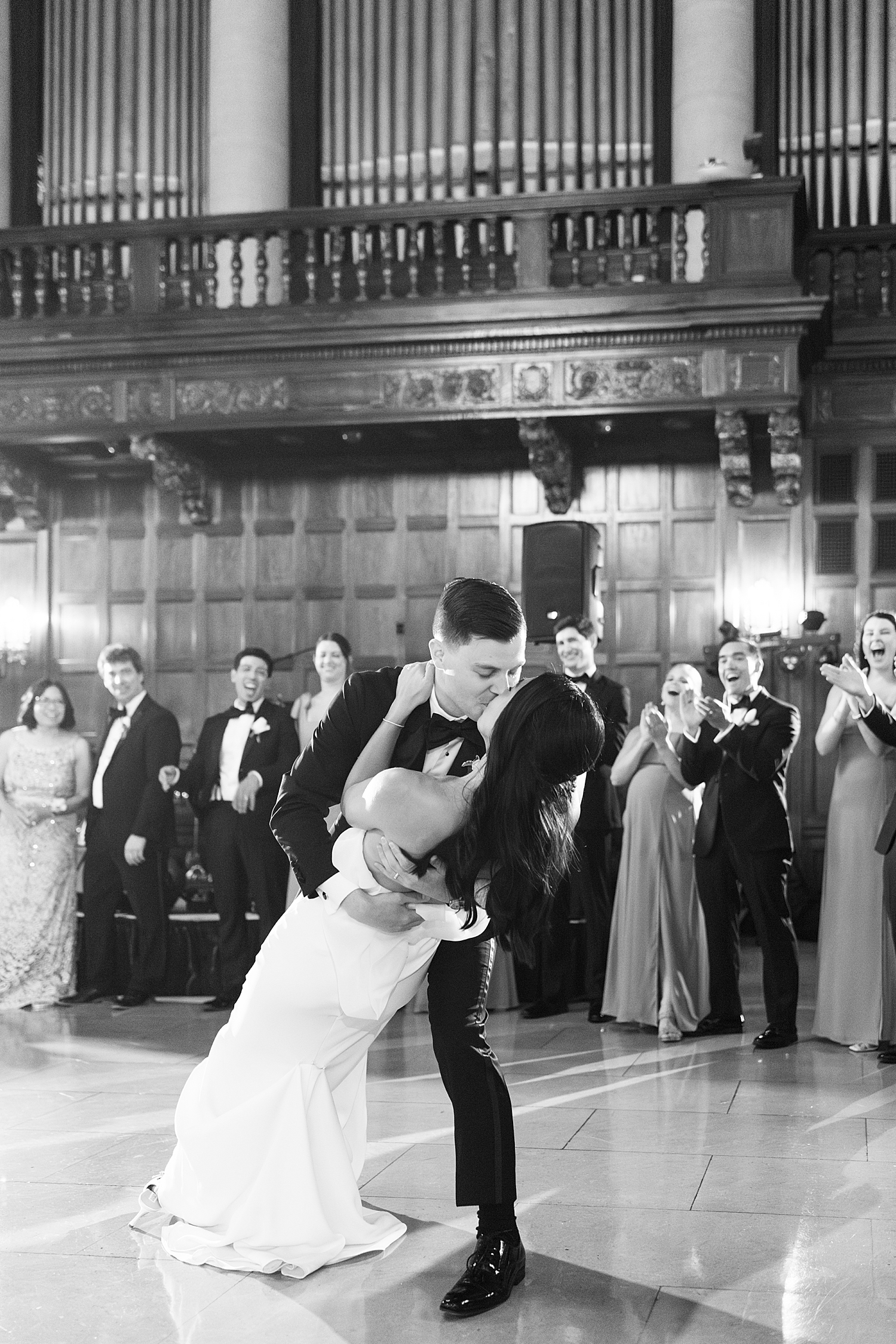 man dips his new wife for a kiss on the dance floor by New England Wedding Photographer