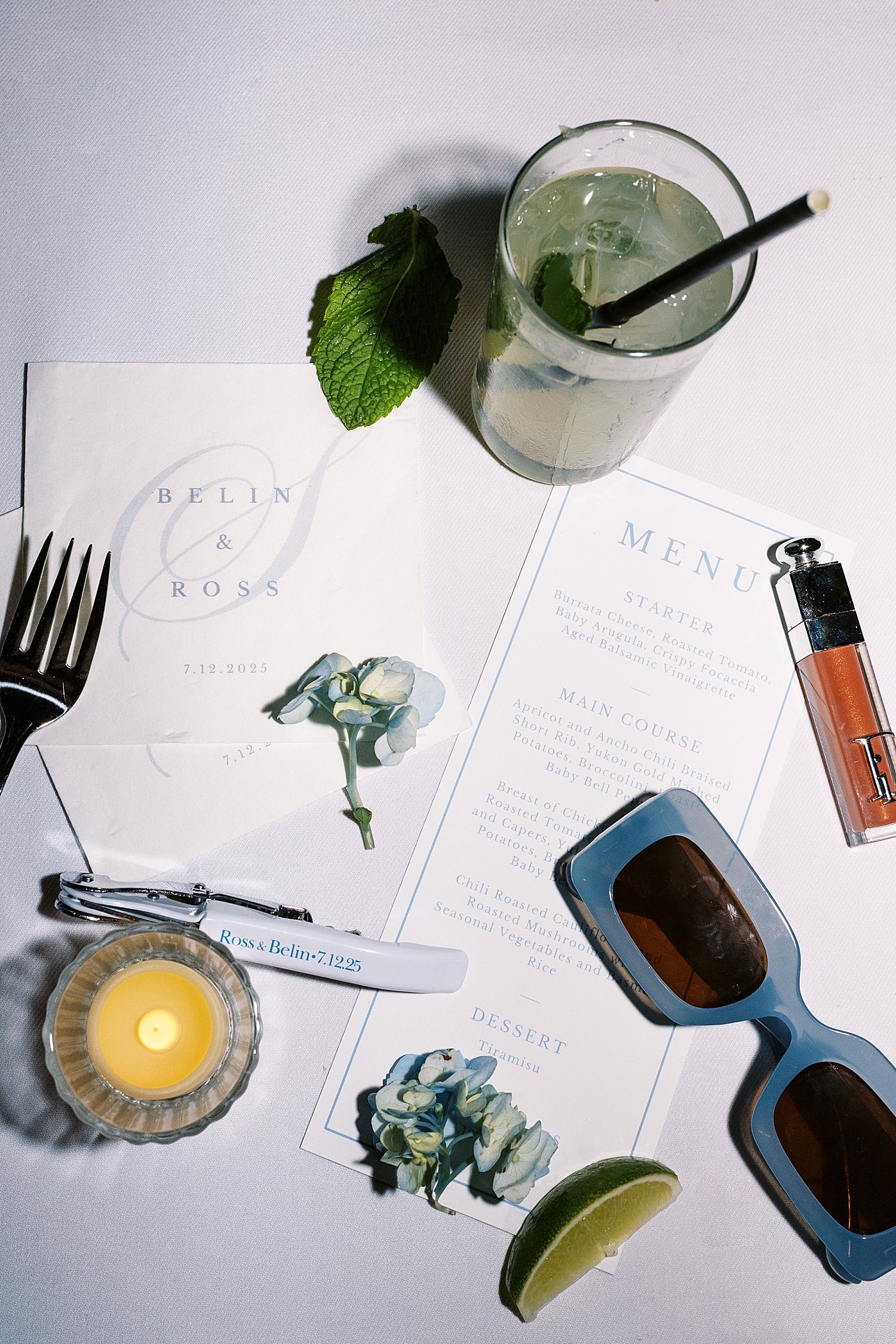 mojito sits on menu at reception table in messy late night flat lay at Harvard Club of Boston