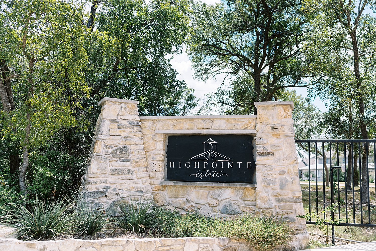 big limestone sign in front of gate for HighPointe Estate