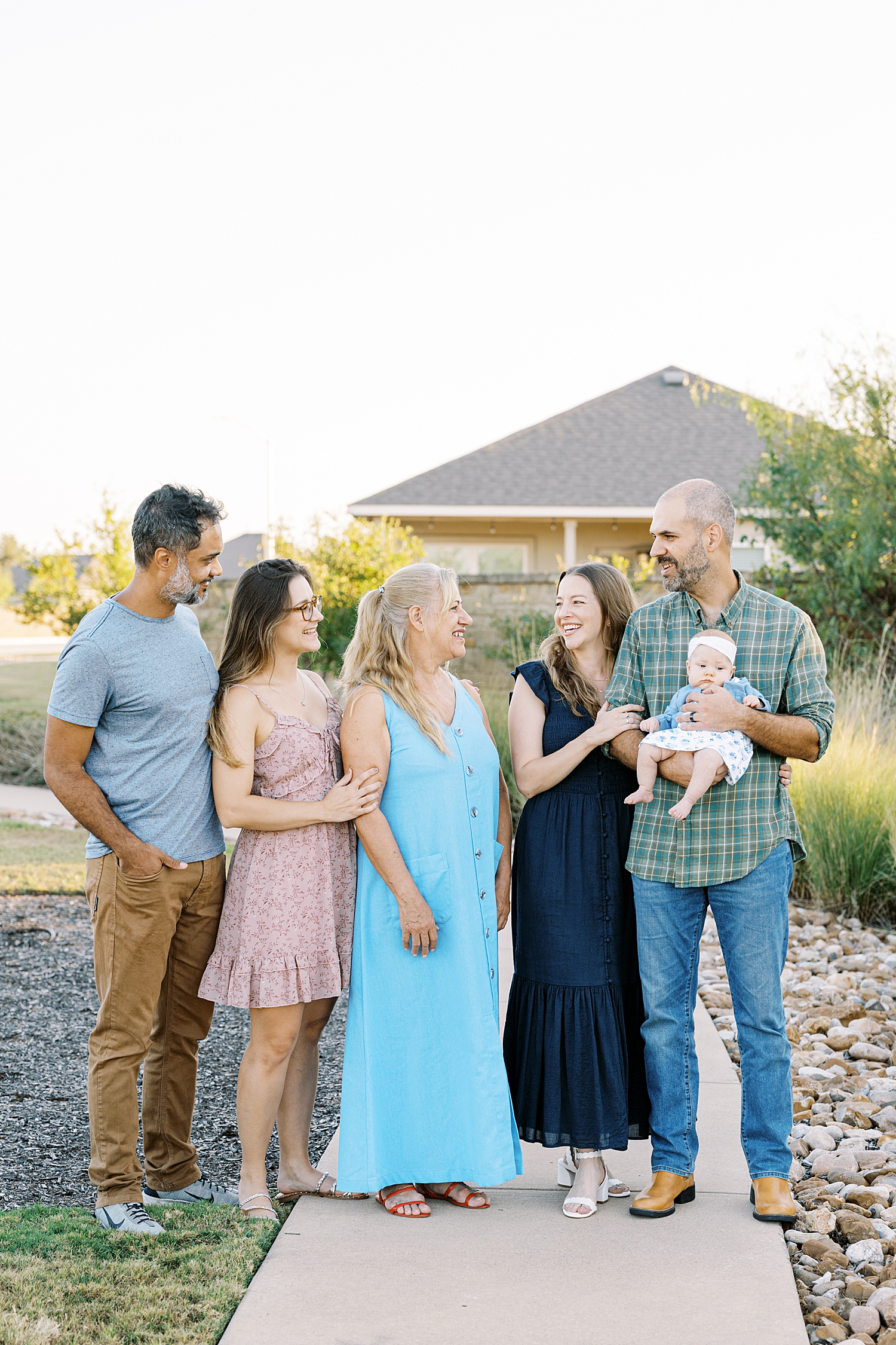 5 adults with baby for newborn family session outside