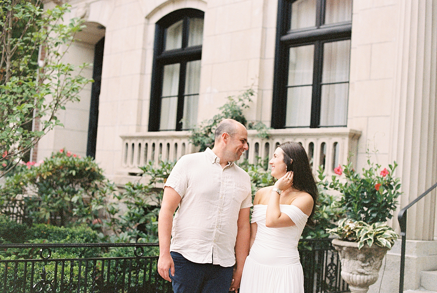 brunette woman smiles at her fiance on street by Boston wedding photographer