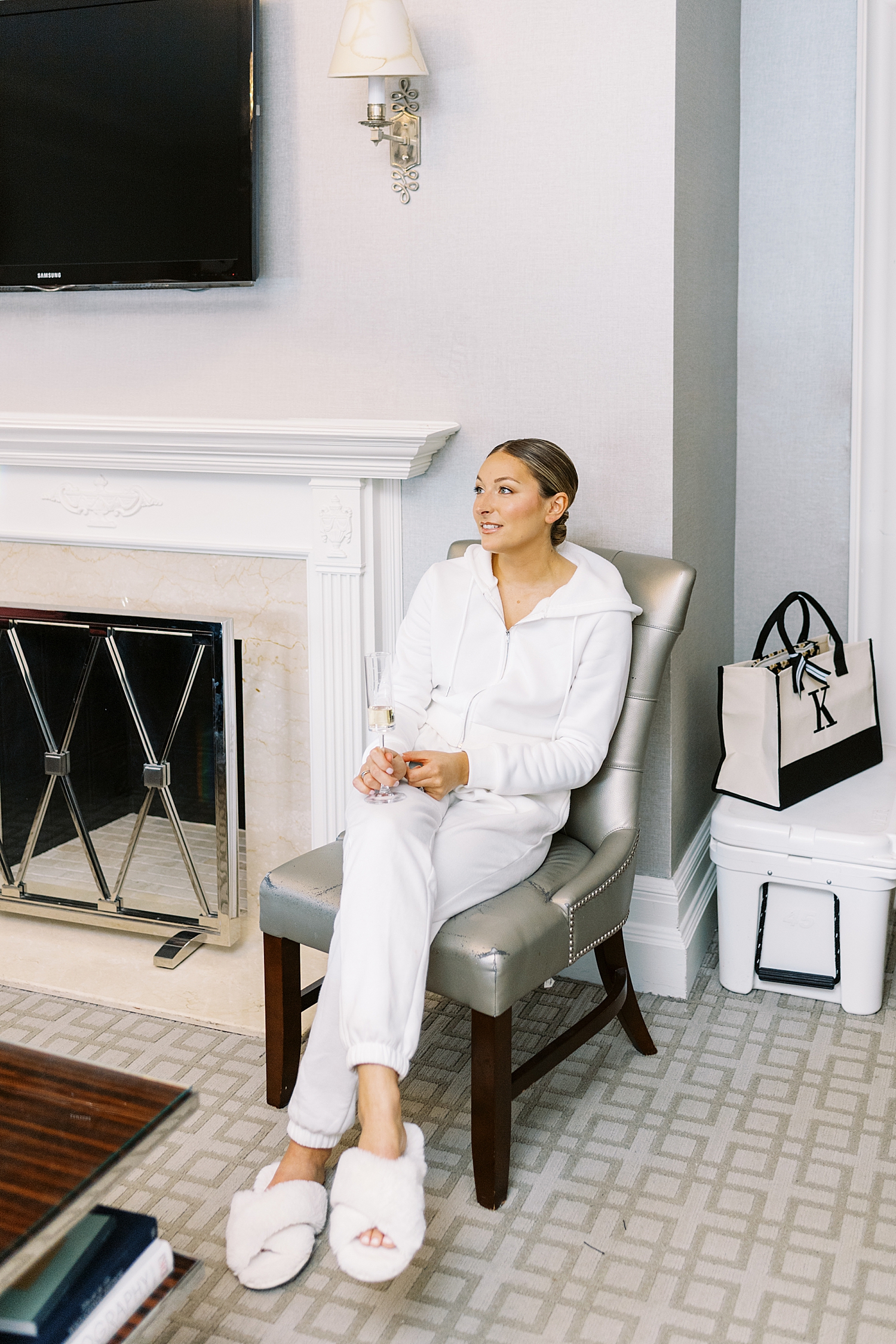 woman in matching white tracksuit in chair by Boston photographer