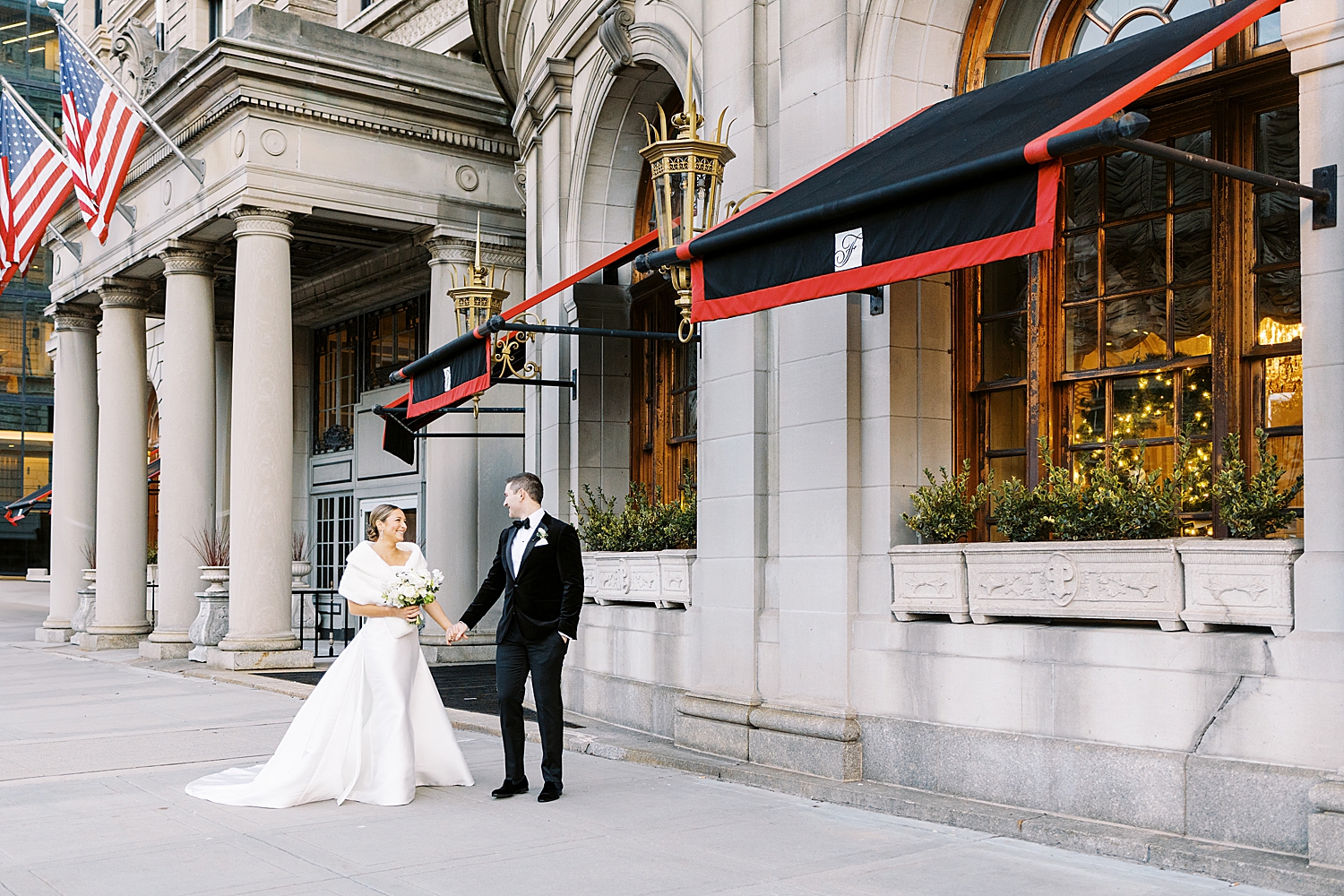 newlyweds stand on the sidewalk together in the cold for NYE wedding weekend
