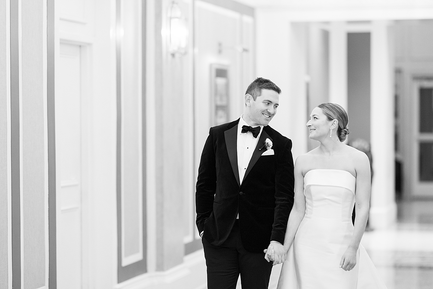 bride and groom walk through hotel lobby for NYE wedding weekend