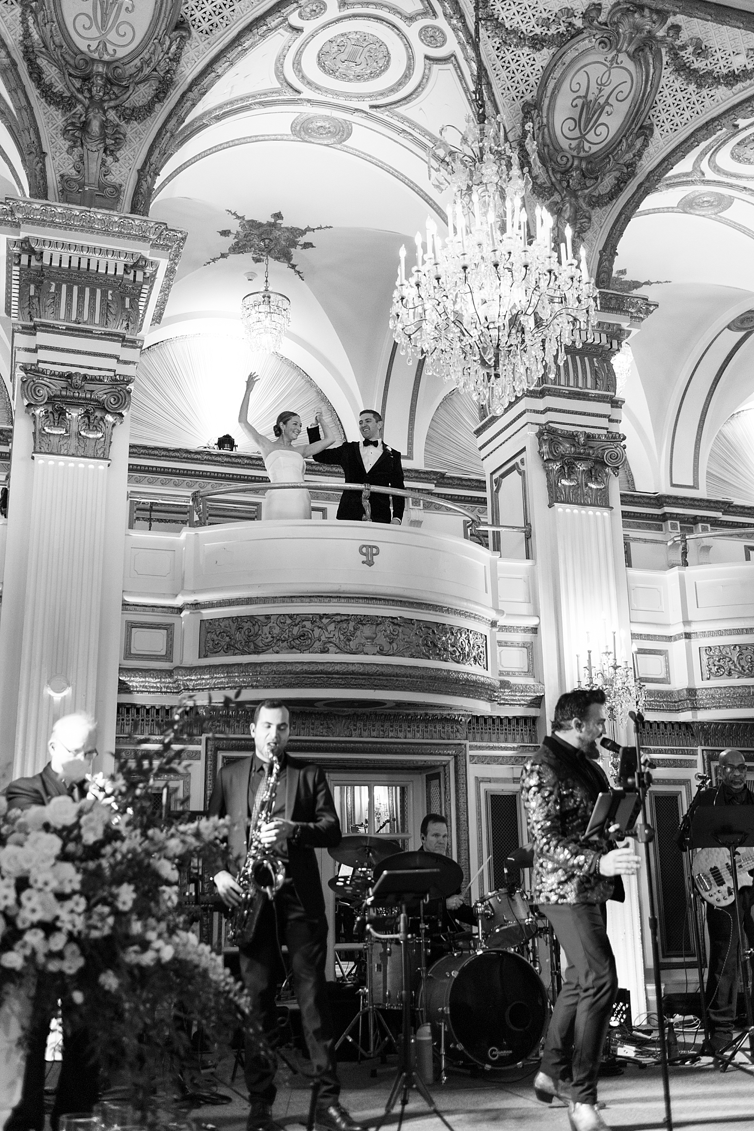 band plays as bride and groom stand on balcony above for NYE wedding weekend