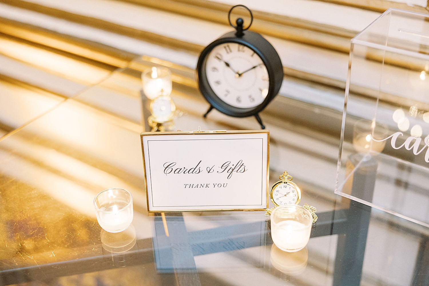 clock sits on table for cards and gifts at NYE wedding weekend
