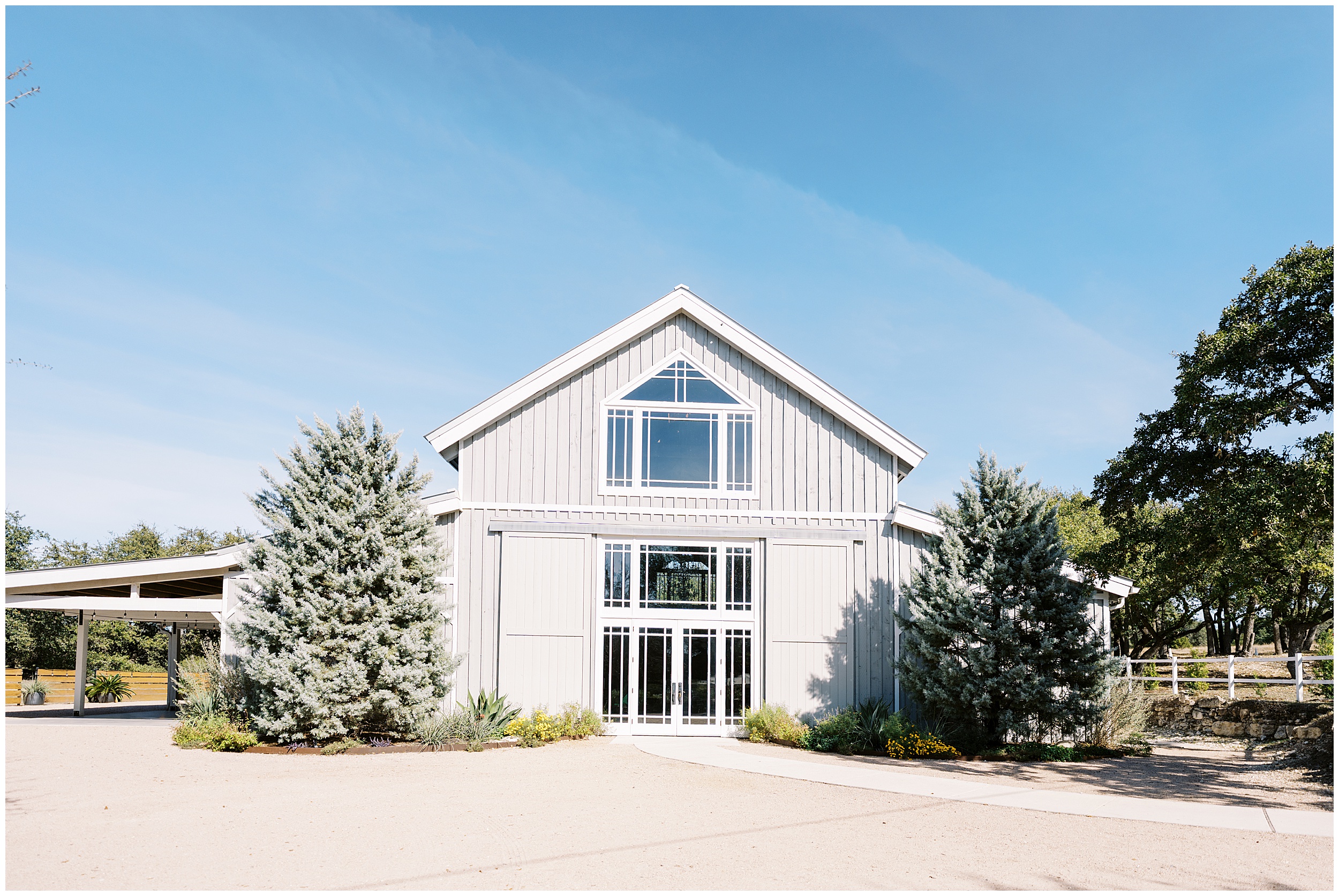 Exterior of Addison Grove wedding venue in Austin Texas with oak trees and open landscape