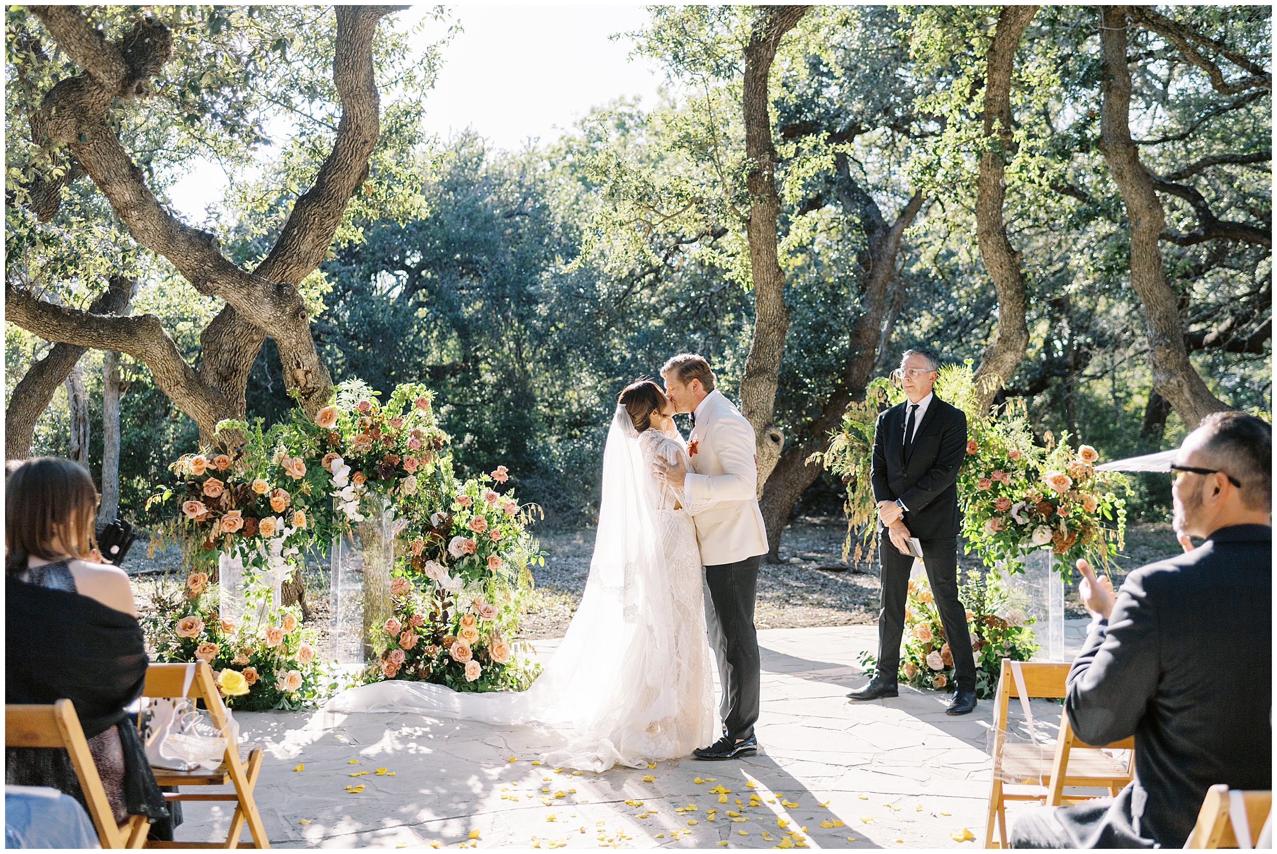 First kiss under oak trees at Austin wedding venue Addison Grove