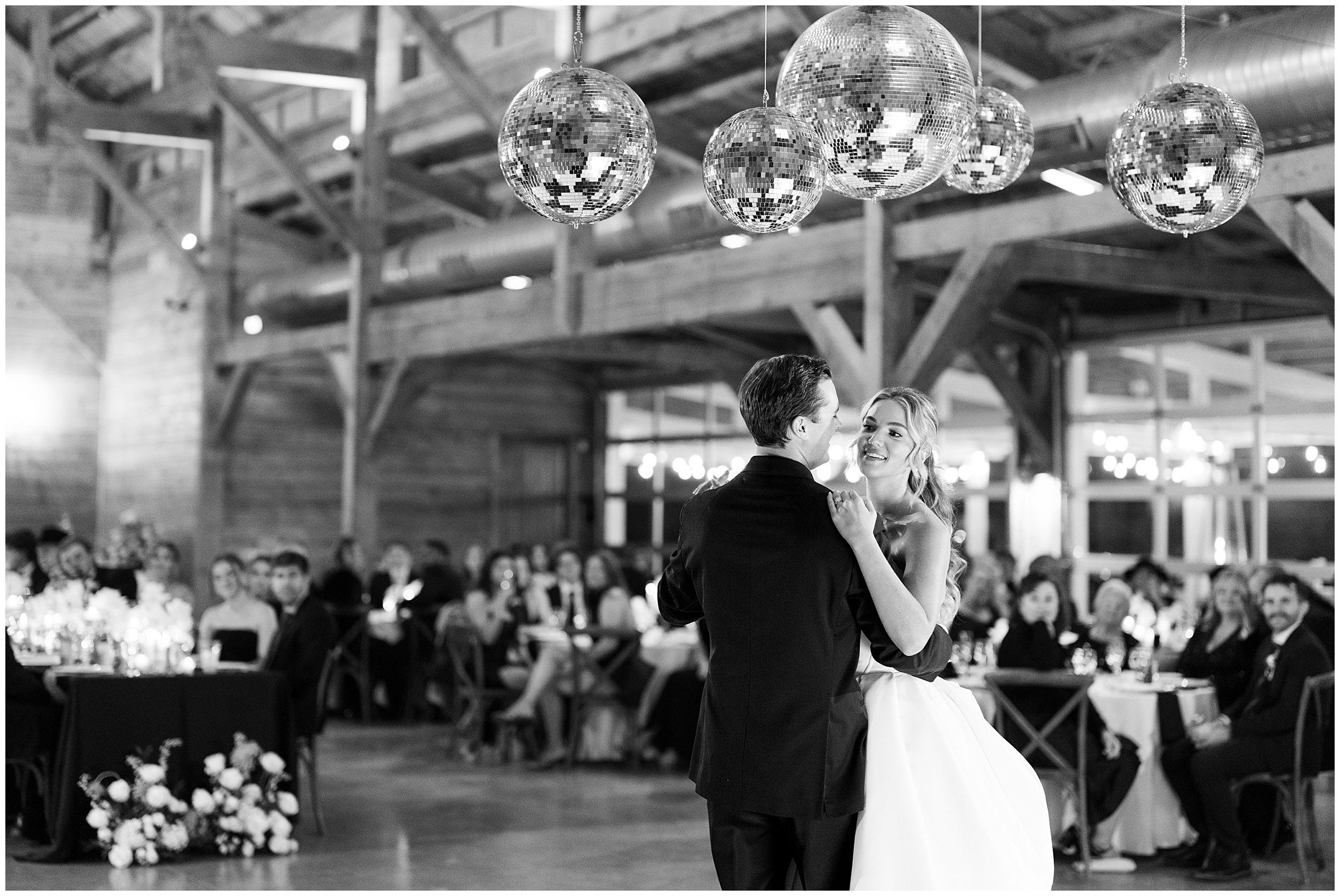 First dance under disco balls in black and white in Addison Grove barn reception space