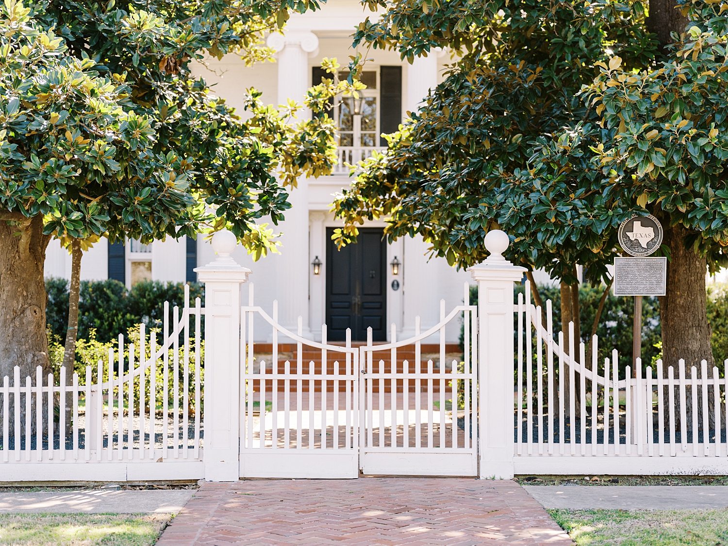 white fence on sidewalk in round rock texas by Austin wedding photographer