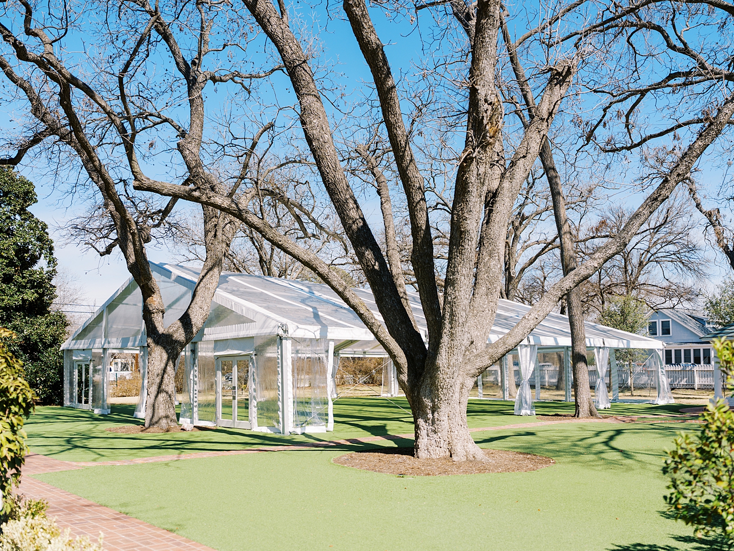 outdoor tent set up on back lawn at Woodbine Mansion