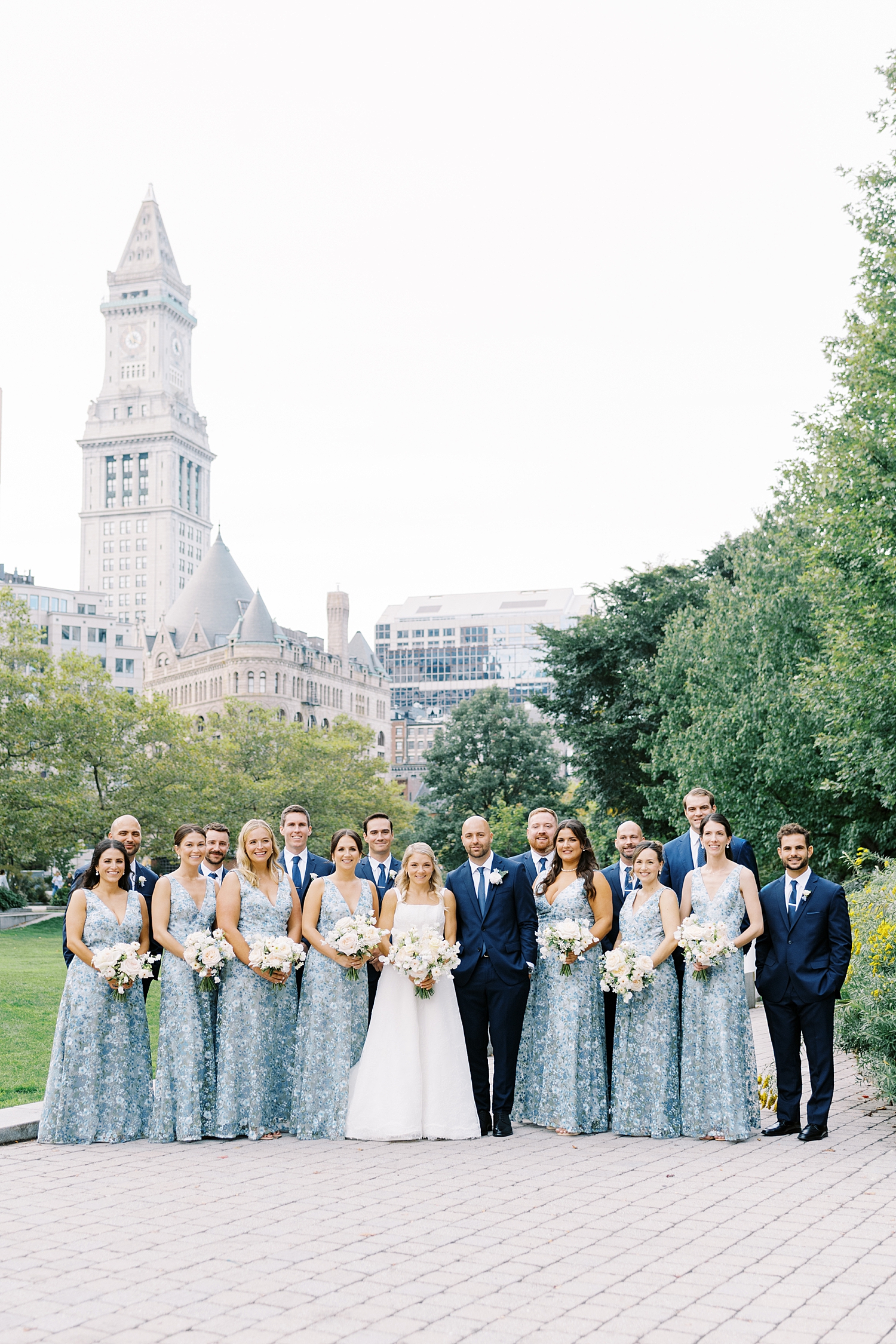 wedding party stands on old historic street by Lynne Reznick Photography