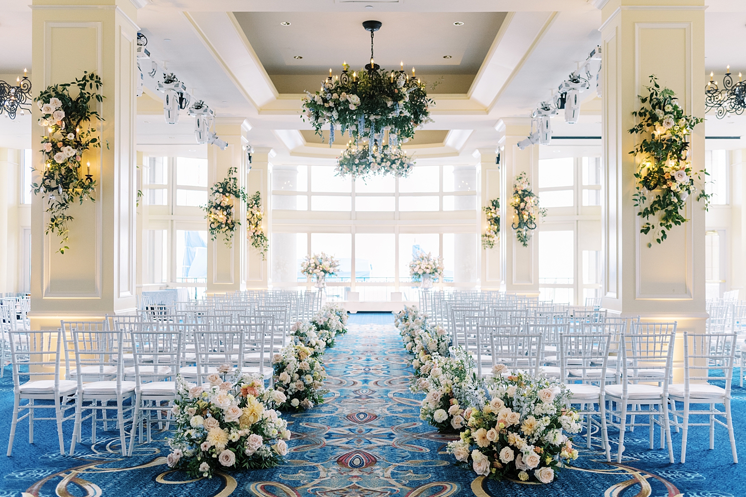 long ceremony space set up with gorgeous florals by New England wedding photographer