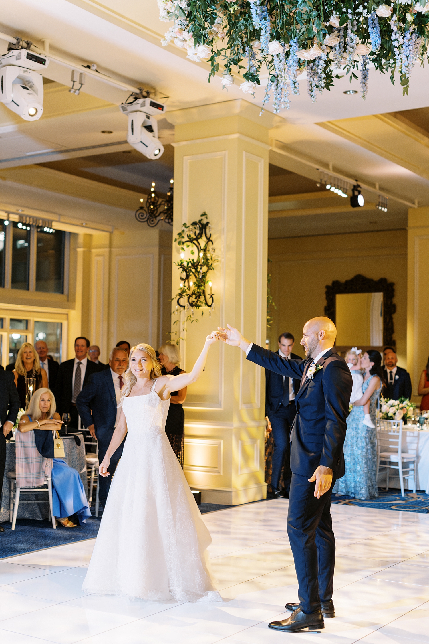 newlyweds arrive on dance floor during ballroom reception by Lynne Reznick Photography
