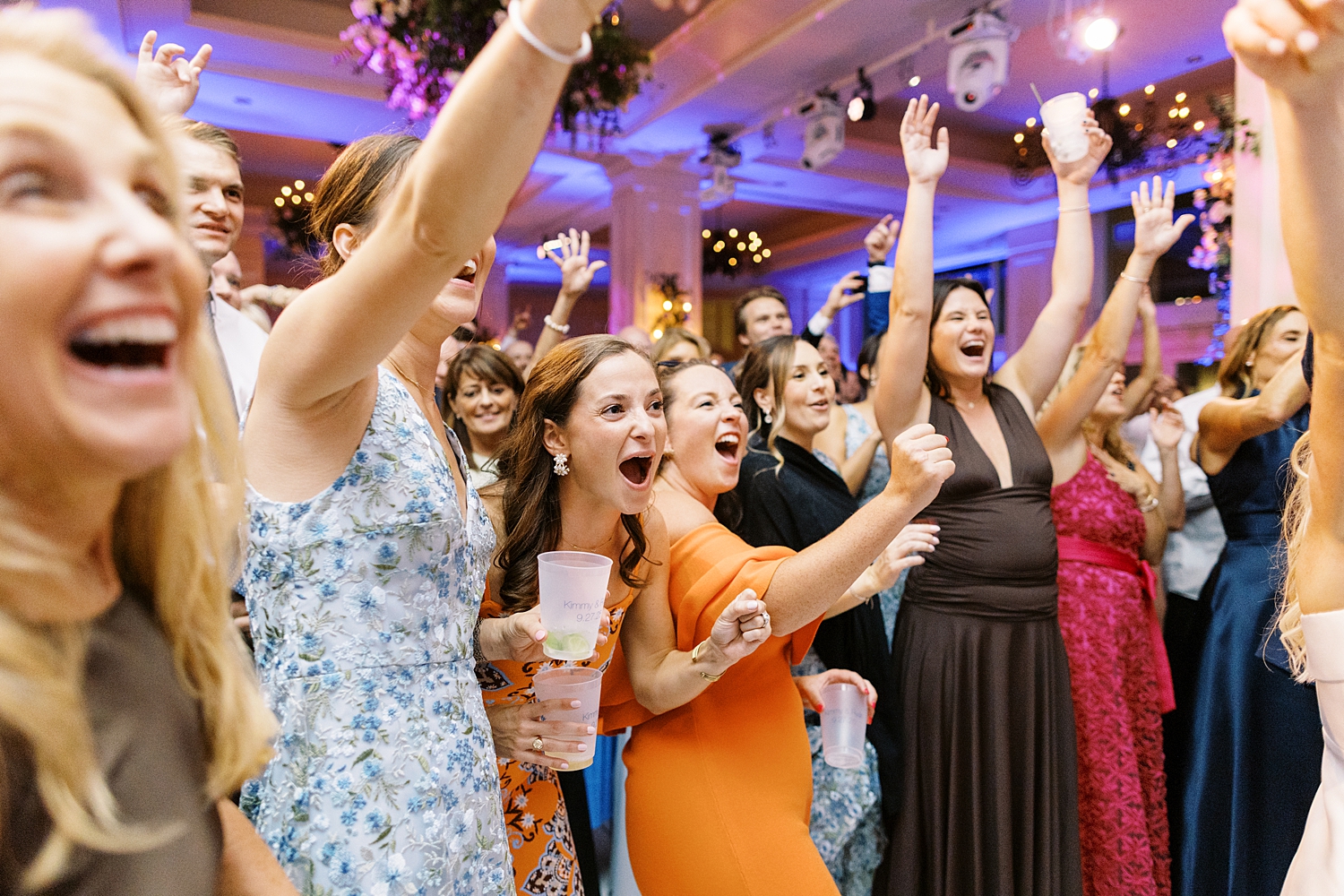 guests dance during reception in ballroom by Lynne Reznick Photography