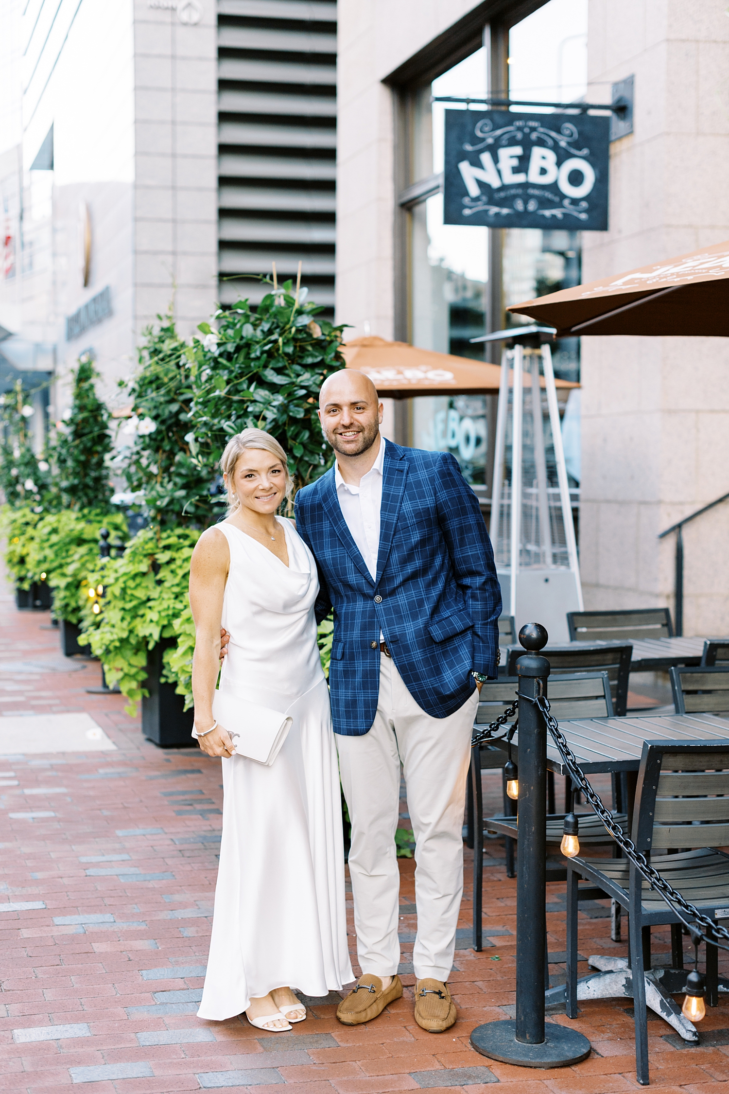 couple stands outside of restaurant before their big day at Boston Harbor Hotel 