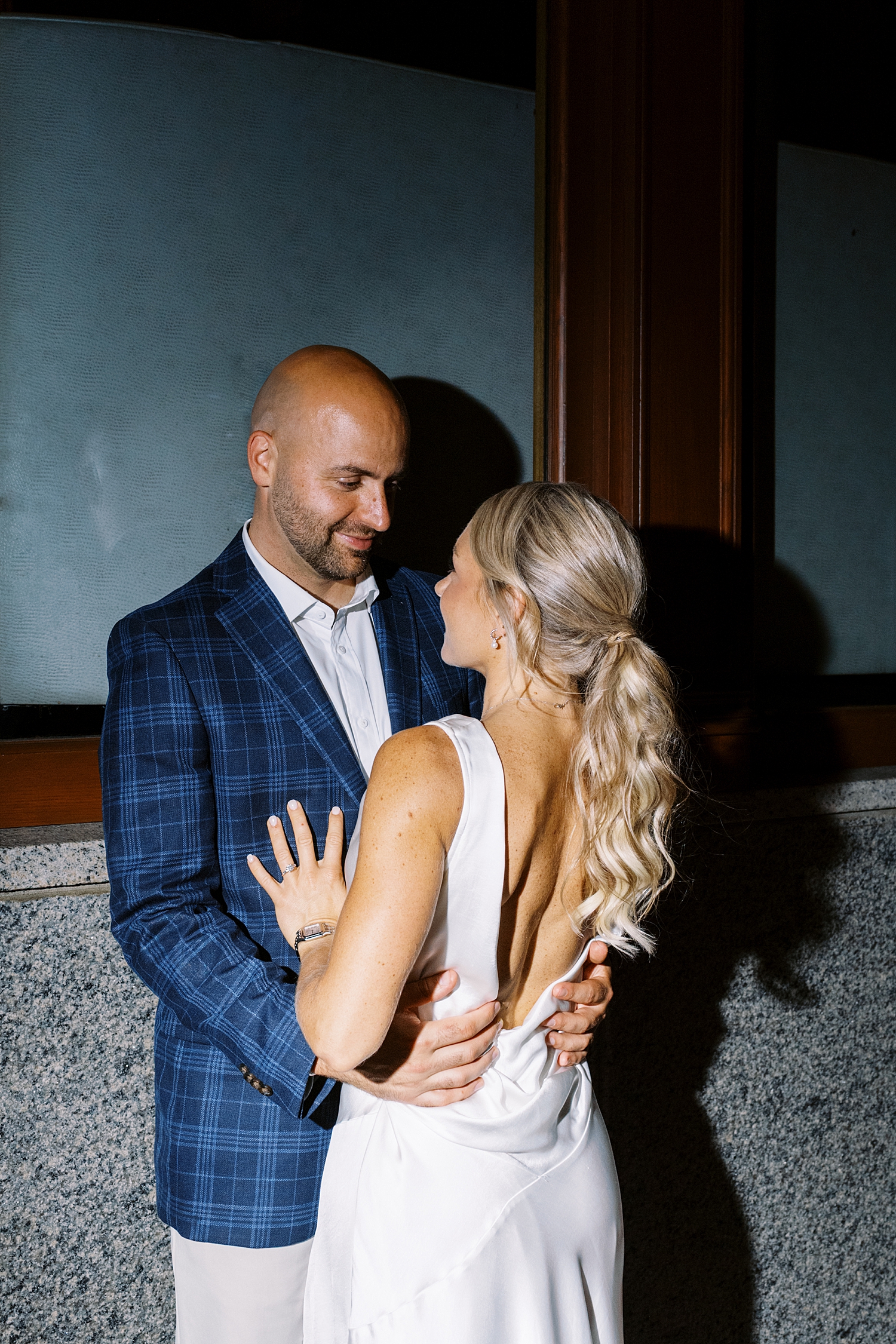 husband and wife to be stand together at welcome dinner by New England wedding photographer