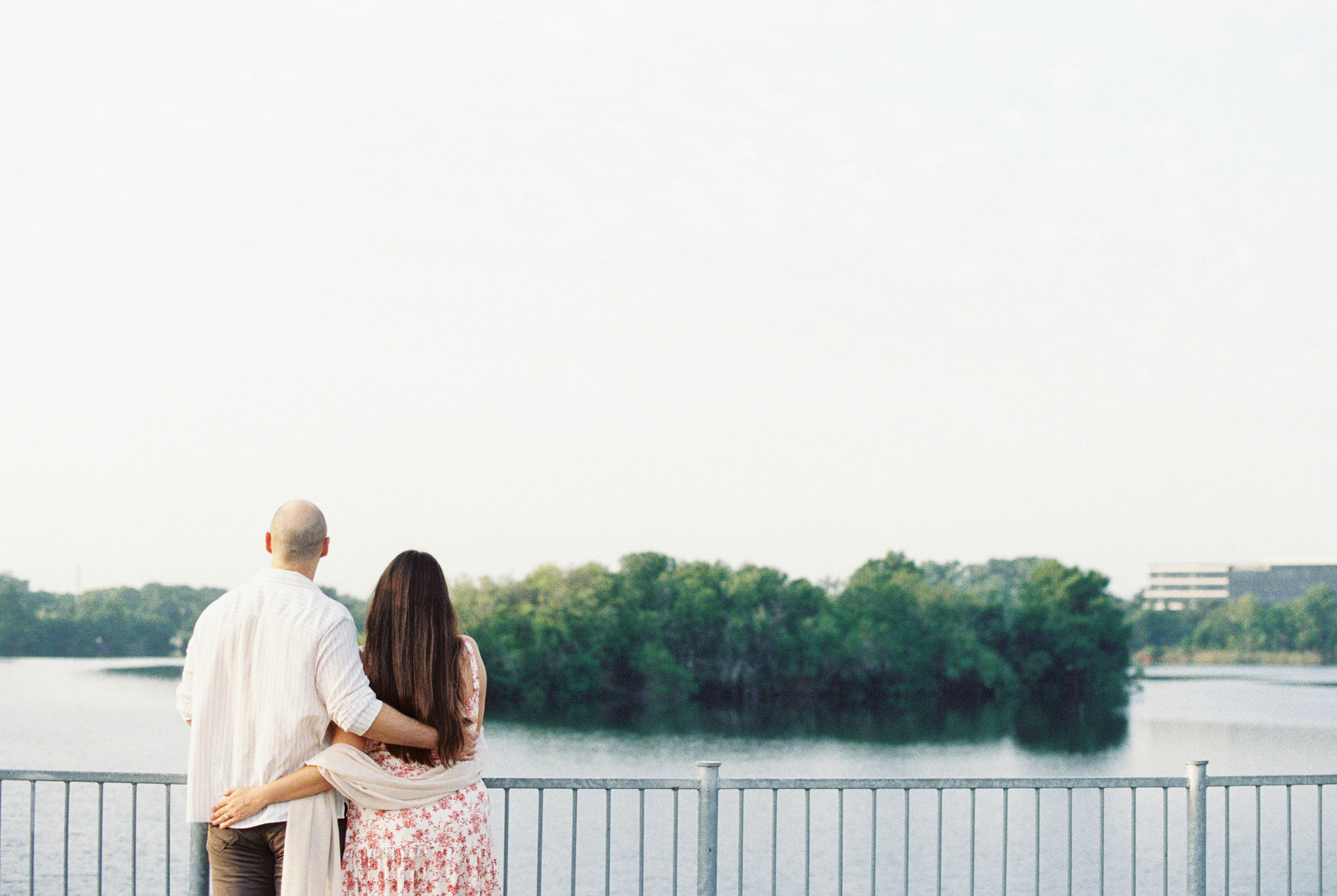 Sweet couple overlooking the lake at their Austin engagement session